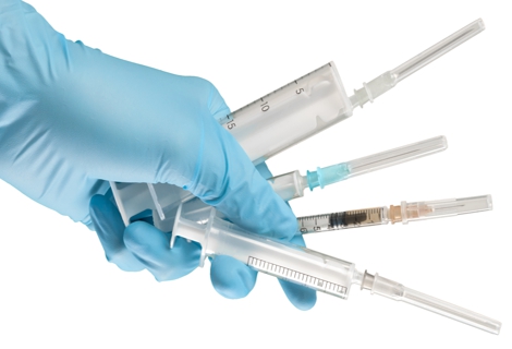 Syringe in hand isolated on white