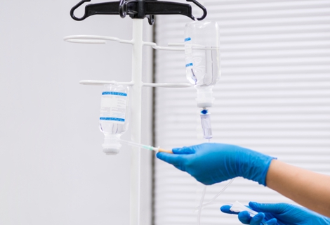 the doctor prepares the system with a dropper and a solution
